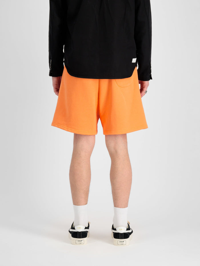 Alpha Essential Relaxed Short by Alpha Industries in bright orange, soft cotton blend, elastic waistband, side pockets.