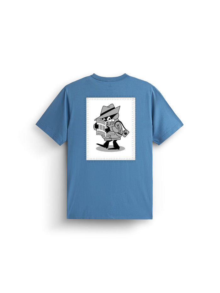 Alpha News Patch Tee by Alpha Industries, elemental blue graphic shirt with black and white back print featuring cartoon spy, hat, trench coat, newspaper, and rolled-up document.