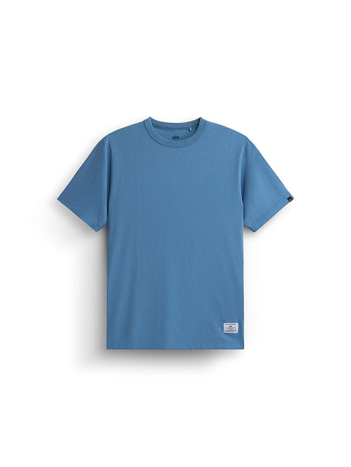 Alpha Industries Alpha News Patch Tee, blue short-sleeve crew neck shirt with small rectangular label near bottom hem.