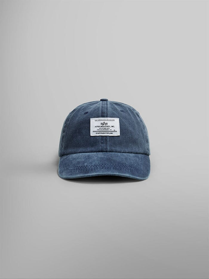 Front view of the Alpha Industries Battlewash Cap in Replica Blue, featuring a vintage-inspired design with a white rectangular Alpha logo patch on the front.