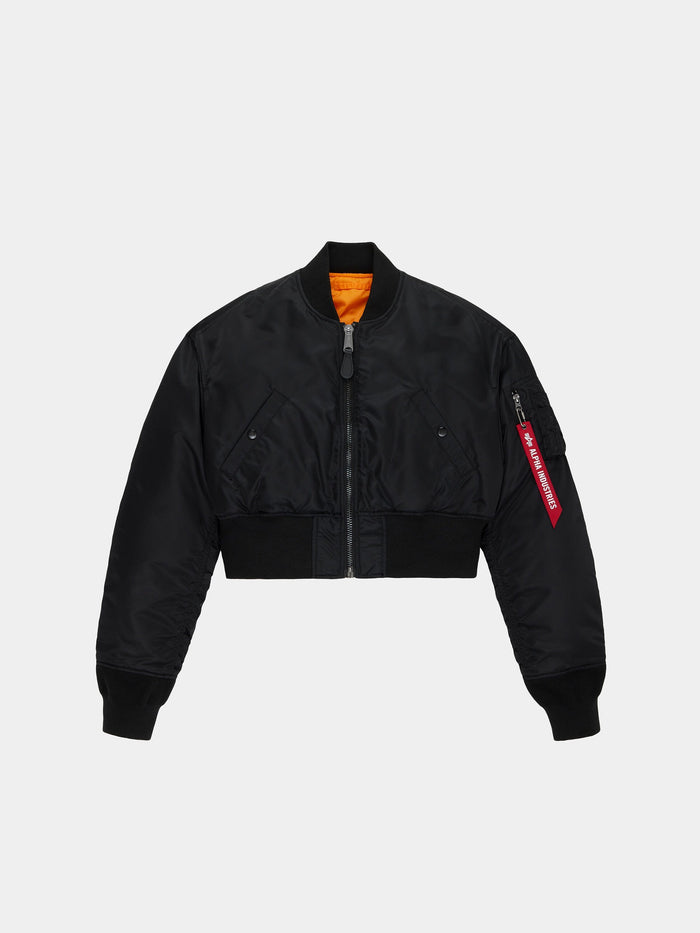 Alpha Industries Cropped MA-1 Flight Jacket Womens in black with front zipper, ribbed cuffs and hem, angled pockets, red sleeve tag, orange lining.