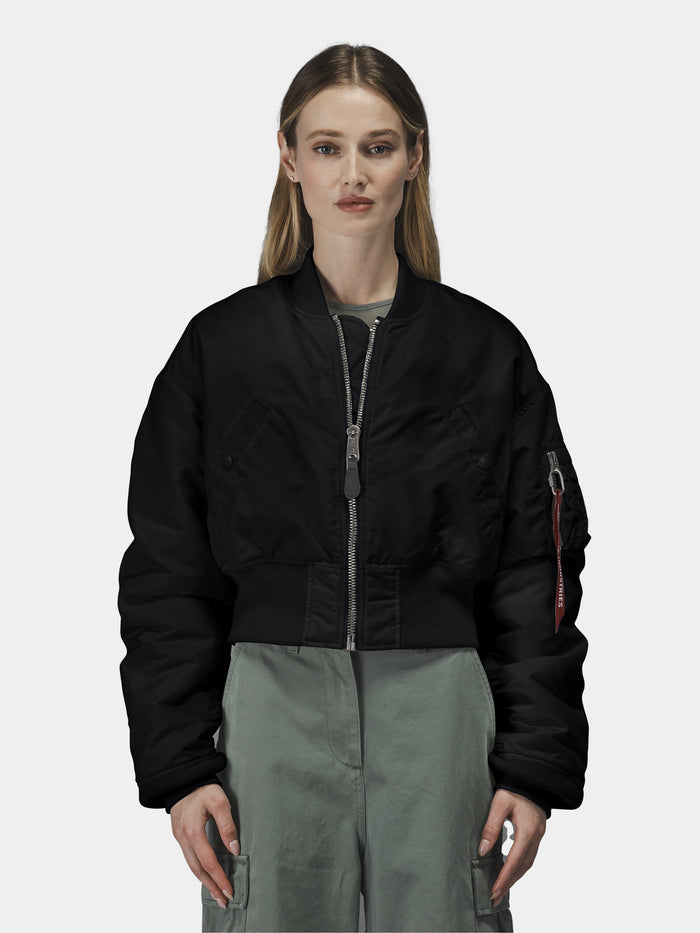 Alpha Industries Cropped MA-1 Flight Jacket Womens in black with front zipper, worn over a green outfit.