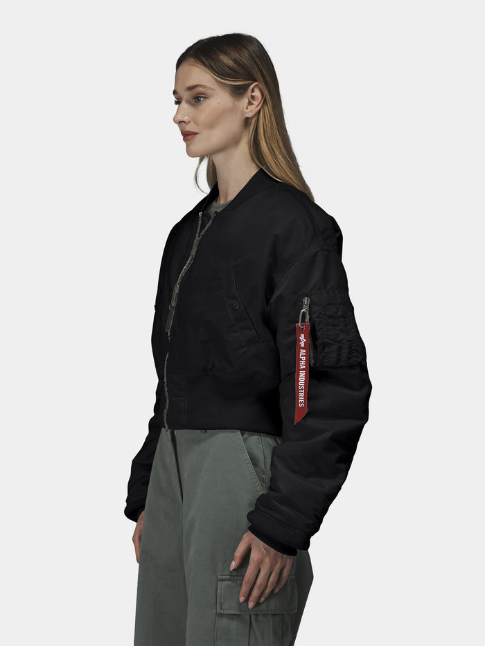 Alpha Industries Cropped MA-1 Flight Jacket Womens with red "Remove Before Flight" tag, olive green cargo pants.