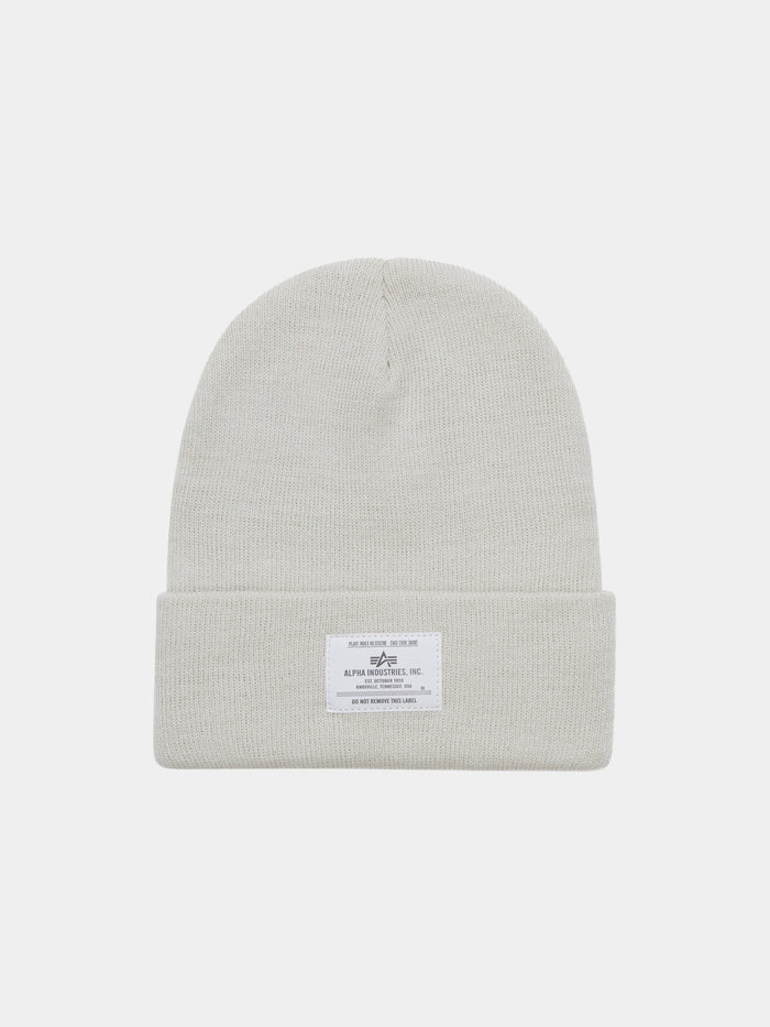 Essential Beanie by Alpha Industries in Dune White with fold-over cuff and rectangular white Alpha label with text and graphic.