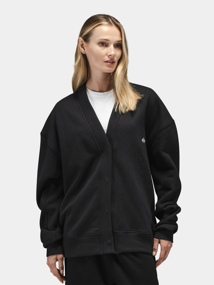Alpha Industries Essential Cardigan, cotton-poly blend, layered over white shirt.