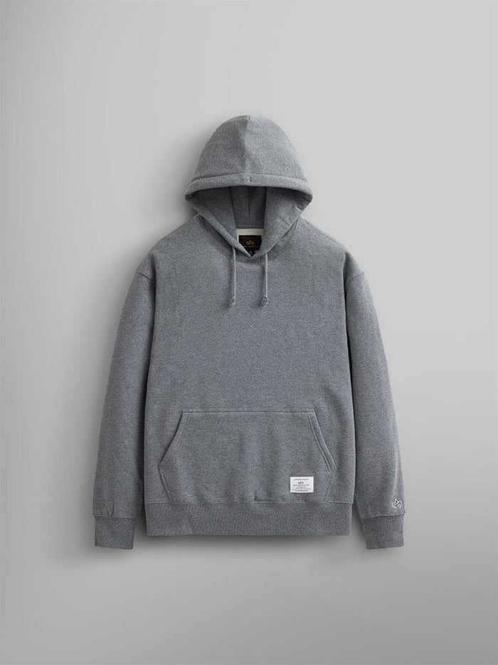 The Essential Hoodie by Alpha Industries showcases its versatility as a wardrobe essential with its front pocket and drawstrings.
