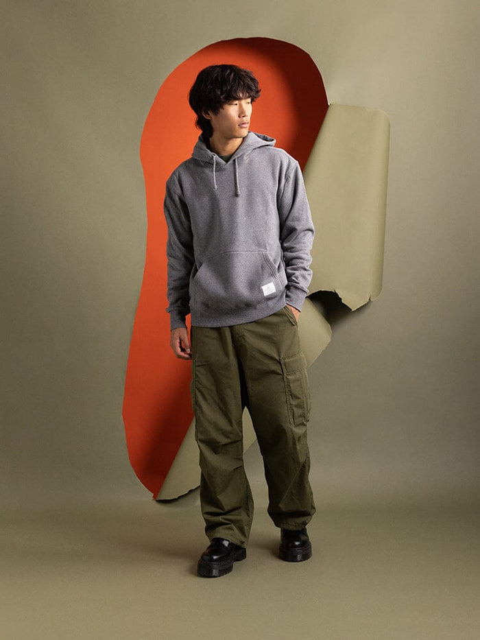 Alpha Industries Essential Hoodie in solid color with drawstring hood and front kangaroo pocket.