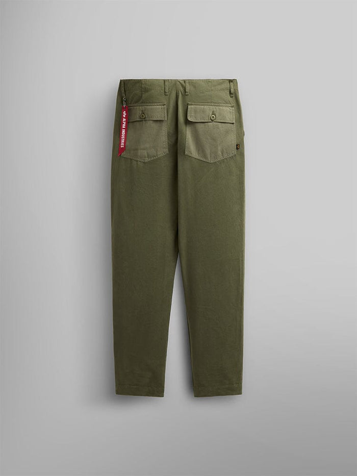 Alpha Industries Fatigue Pant in Olive Green Cotton with Two Buttoned Utility Pockets and Red Fabric Tag on Right Pocket.