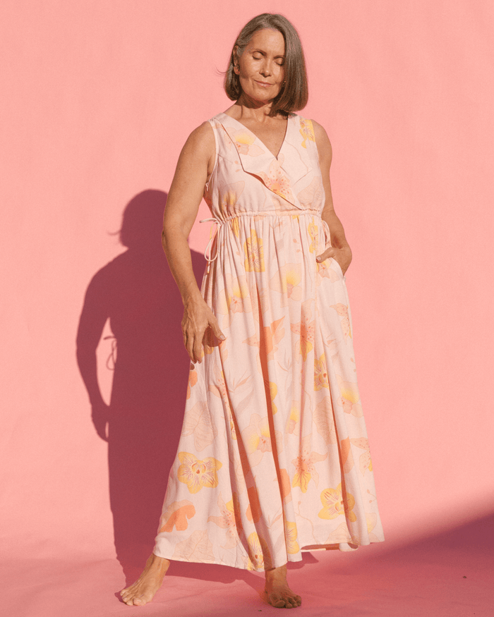 Woman wearing a flowy spring time light pink floral dress.