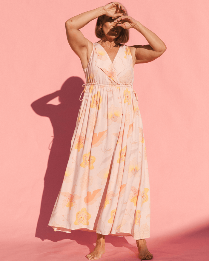 Woman wearing floral breastfeeding friendly dress.