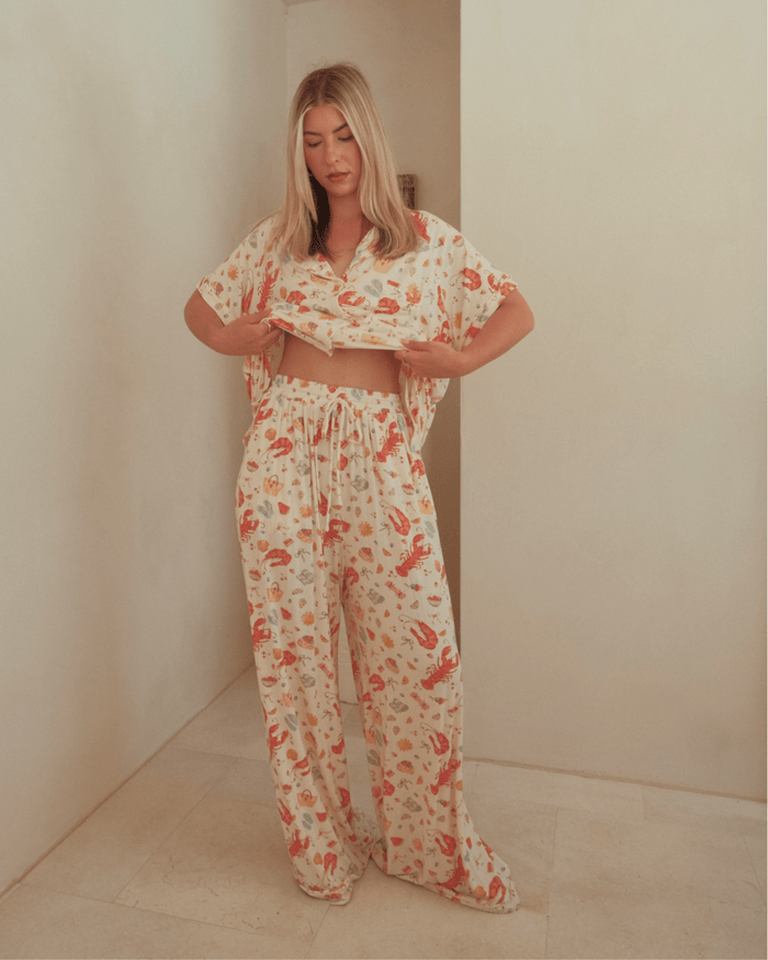 Woman wearing long, breathable pj pants with adjustable tie, waistband.