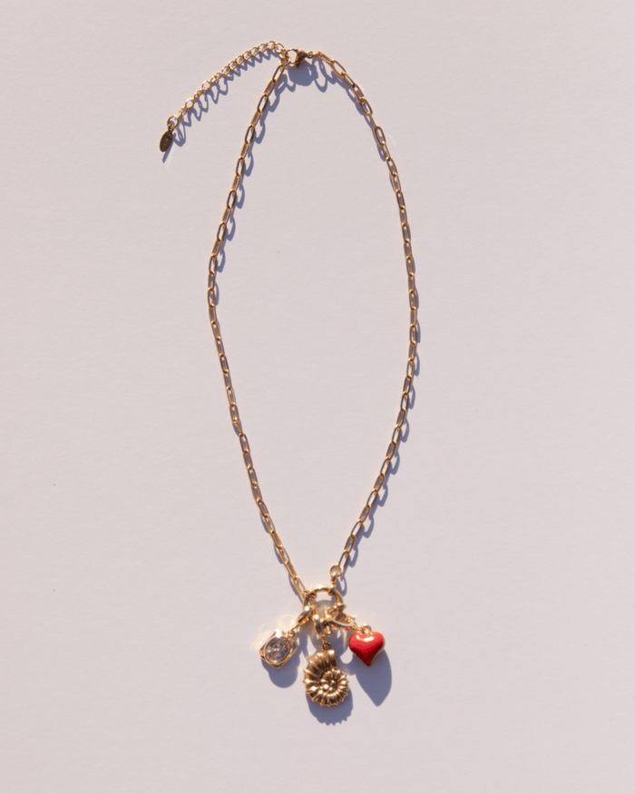 Adjustable gold link charm necklace with gold charms attached.