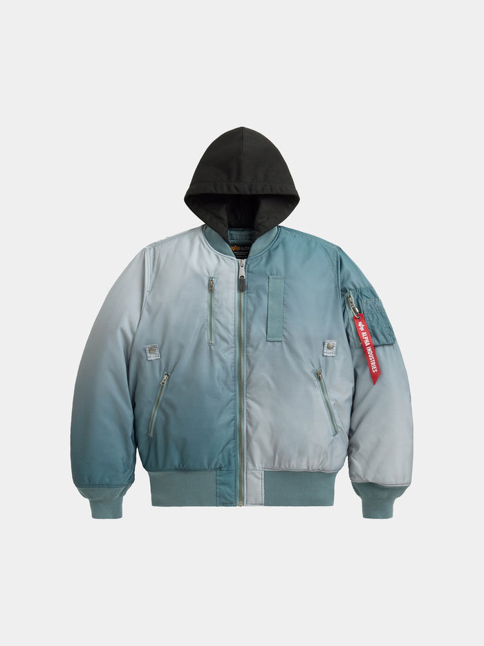 Alpha Industries Gradient Washed Flight Jacket in Aviator Blue with gradient design, black hood, front zipper, zippered pockets, red Remove Before Flight tag.