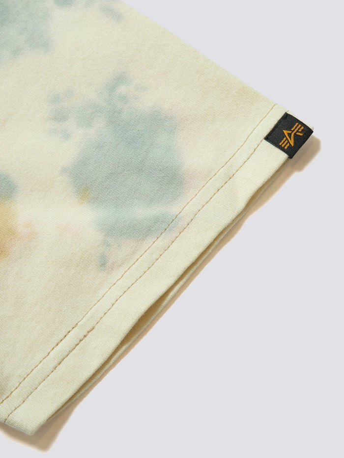 Gramicci X Alpha Cotton Camo Tie Dye Tee by Alpha Industries, light tie-dye cotton fabric, small black and yellow Gramicci logo tag at hem.
