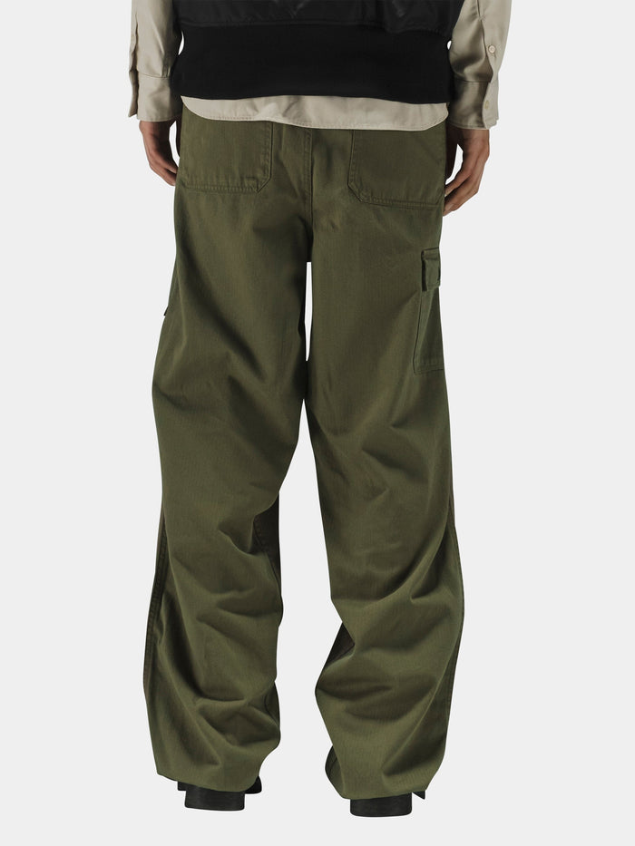 Alpha Industries Hungarian Fatigue Mod Pant in olive green cotton herringbone, beige shirt, and black jacket.