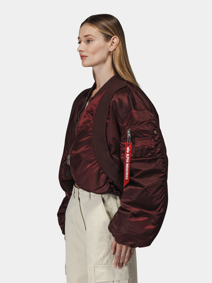 Alpha Industries Knit Rib MA-1 Flight Jacket Womens in maroon with Remove Before Flight tag, high-waisted beige pants.