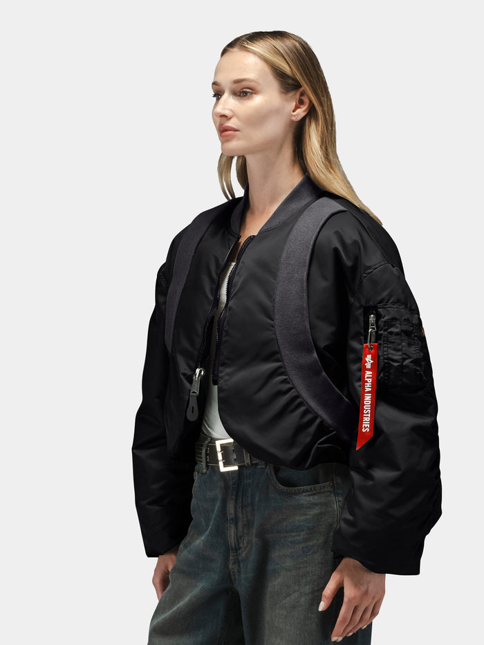 Alpha Industries Knit Rib MA-1 Flight Jacket with red Remove Before Flight tag and dark backpack.