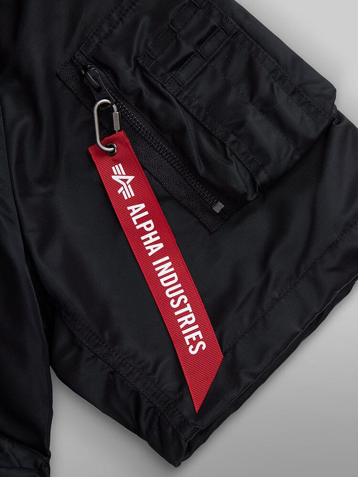 L-2B Short Sleeve Bomber Jacket by Alpha Industries, black water-resistant nylon sleeve with zippered utility pocket and red Alpha Industries tag on metal keyring.