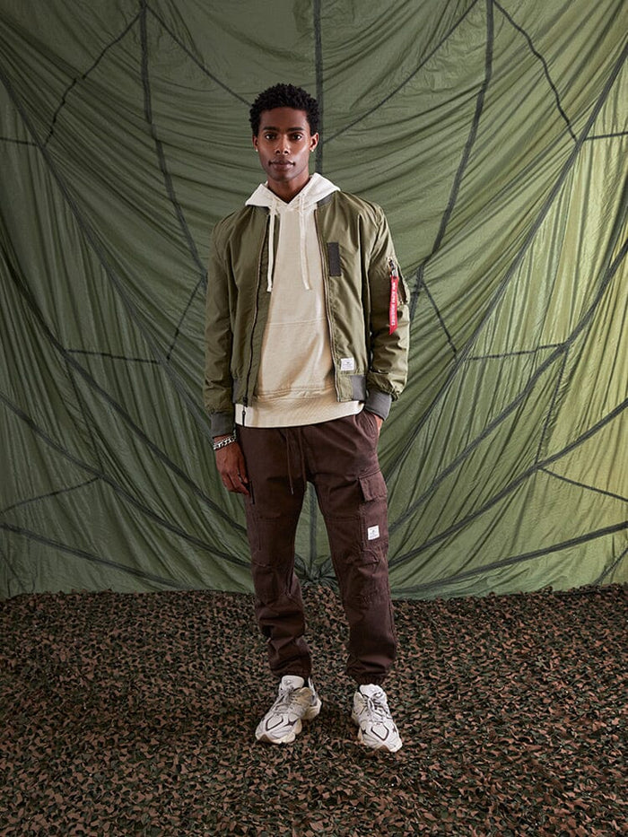 Alpha Industries L-2B Skymaster Gen II Bomber Jacket, green, lightweight nylon, MA-1 utility pocket, oxygen tab details.