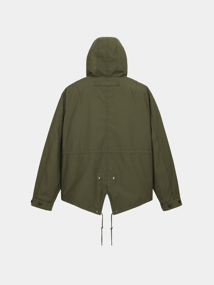 Alpha Industries M-65 Mod Fishtail Field Coat in olive green with fishtail hem, adjustable drawstrings, and buttoned cuffs.