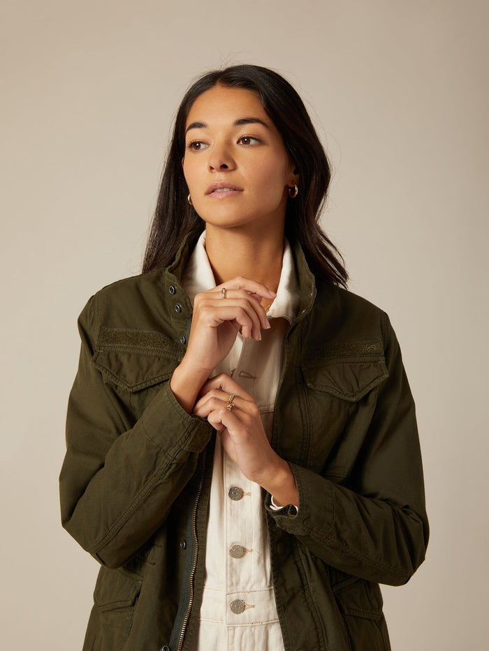 Alpha Industries M-65 Mod Lightweight Field Jacket W, 100% cotton exterior, light color, button-up front.