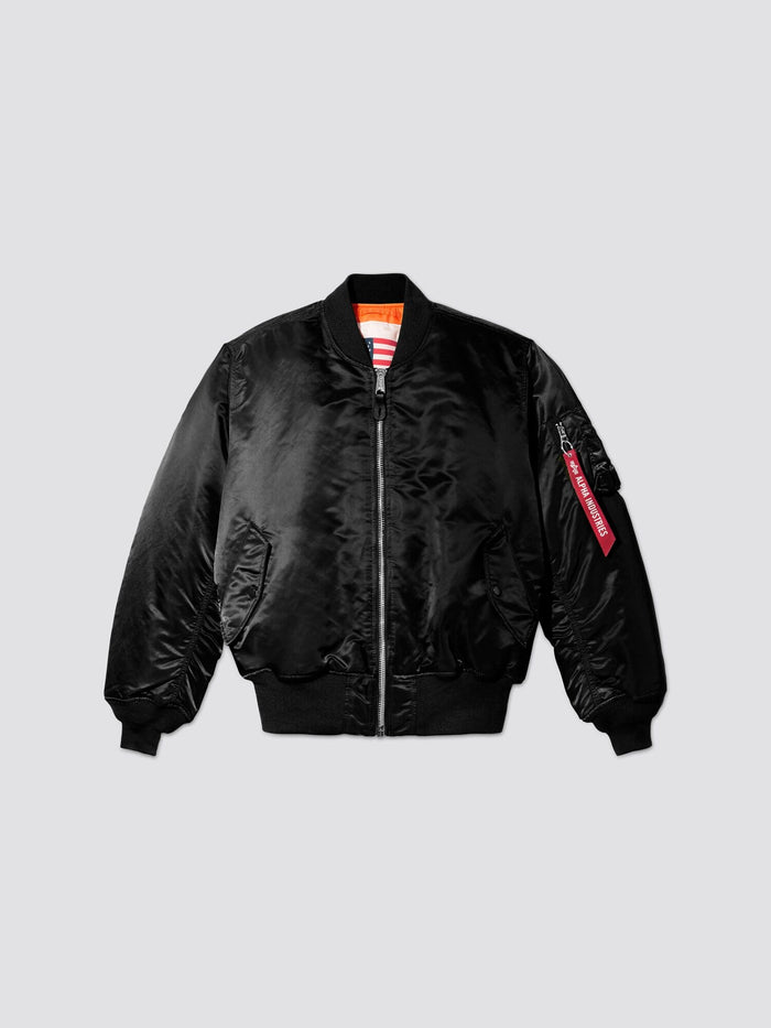Alpha Industries MA-1 Blood Chit: black flight jacket, front zipper, ribbed cuffs and hem, two front pockets, sleeve zip pocket with red tag.