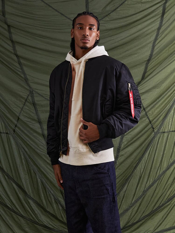 Alpha Industries MA-1 Bomber Jacket in green flight nylon with zippered front, ribbed cuffs, and waistband.