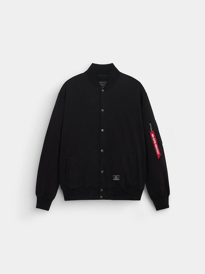 Alpha Industries MA-1 Fleece Jacket in black with snap buttons, ribbed collar and cuffs, two front pockets, red sleeve tag.