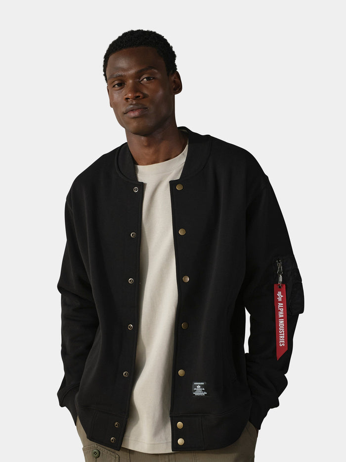 Alpha Industries MA-1 Fleece Jacket in black, fleece material with front zip closure over a beige t-shirt.