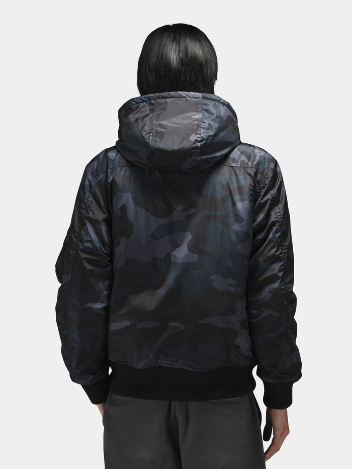Alpha Industries Hooded Rib Flight Jacket with utility sleeve pocket and dark pants.