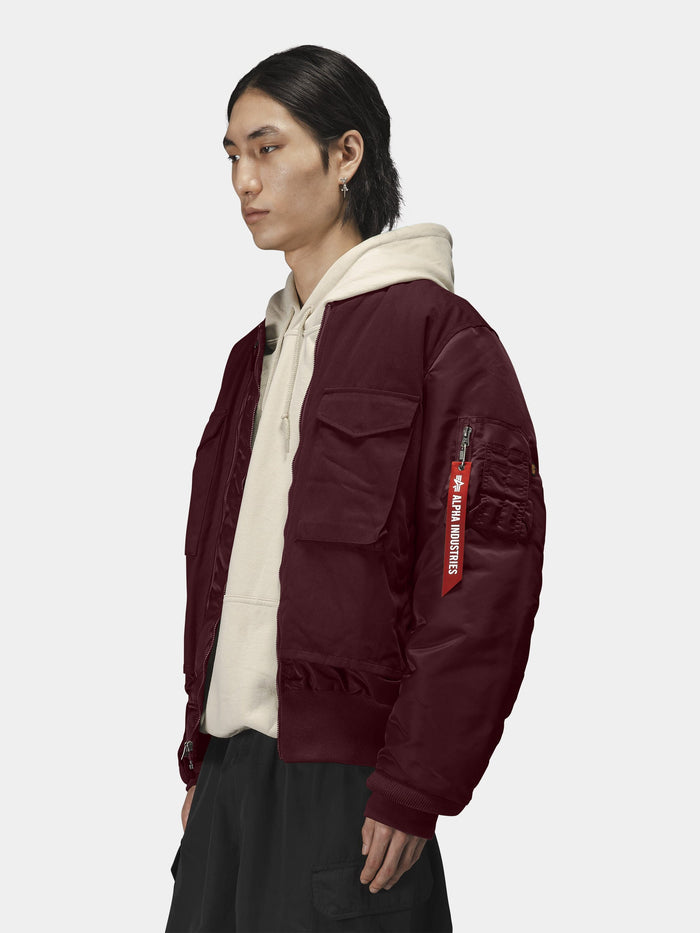 Alpha Industries MA-1 Mixed Cotton Flight Jacket in maroon, beige hoodie, black pants.