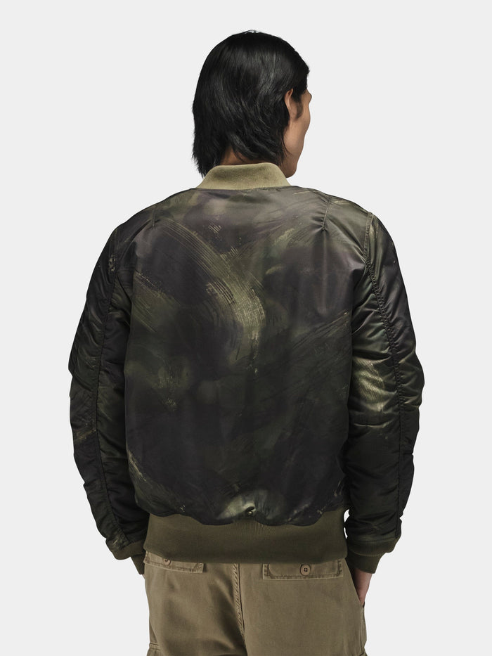 Green Alpha Industries MA-1 Mod Bomber Jacket with utility pocket, khaki pants.