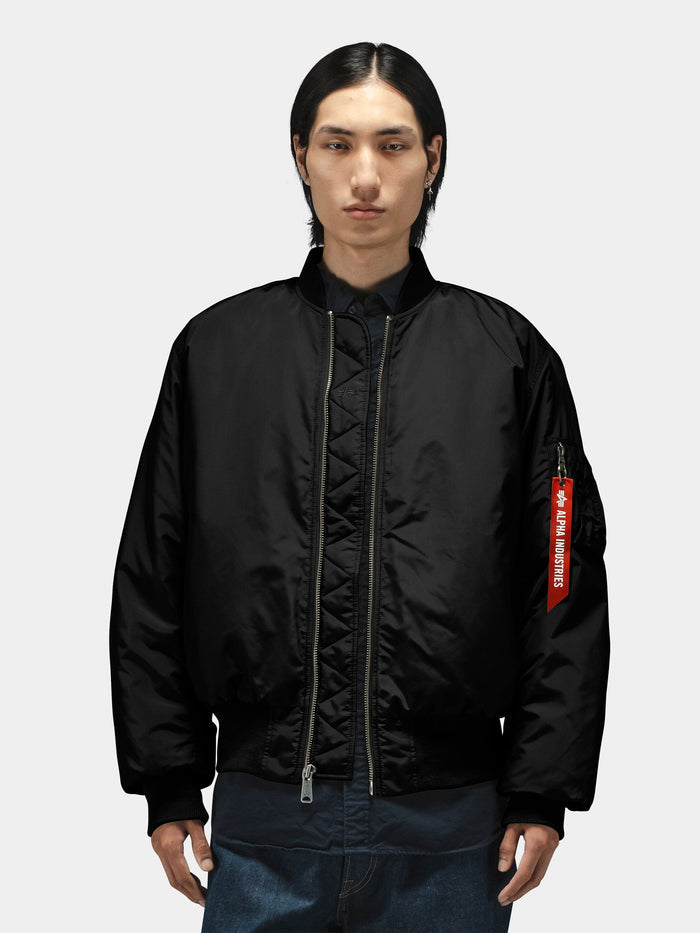 Alpha Industries MA-1 Oxford Flight Jacket, black with visible red tag on sleeve.