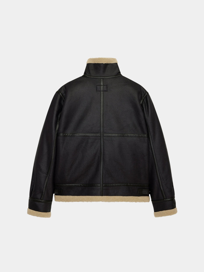 Alpha Industries Mouton B-3 jacket in black faux leather with beige shearling lining and trim.