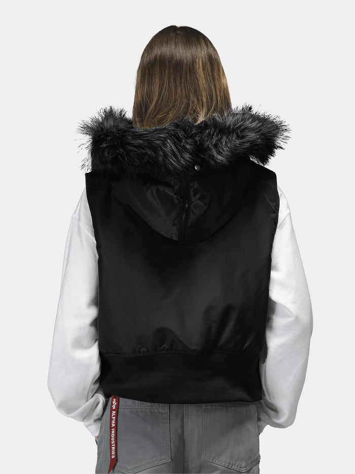 Alpha Industries N-2B Vest Womens in black with faux fur hood, white long-sleeve shirt, gray pants with red tag.