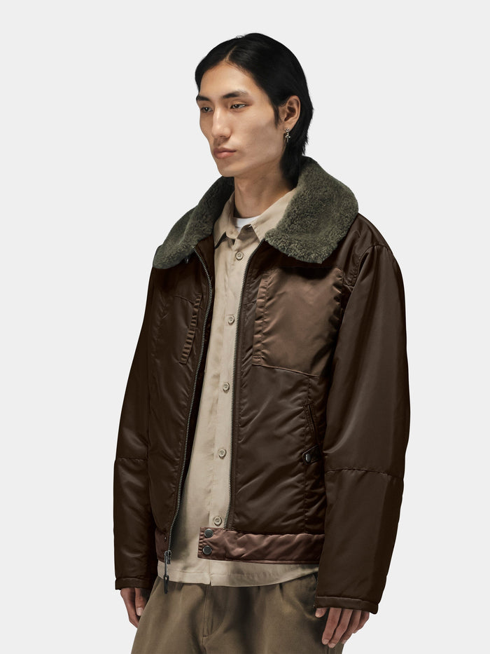 Alpha Industries Nylon Aviator Jacket in brown flight nylon with green faux fur collar. Beige shirt and khaki pants included.