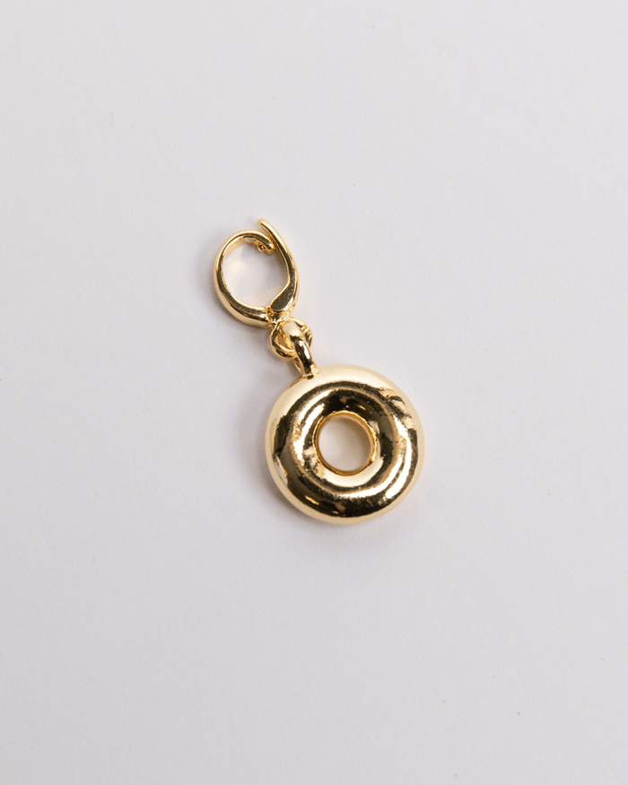 A gold-colored charm in the shape of the letter O with a secure clasp designed for attaching to necklaces or bracelets.