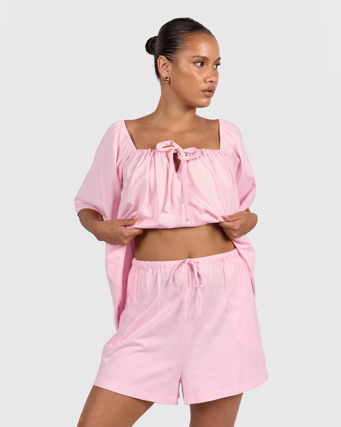 Woman wearing breastfeeding and bump friendly pj top
