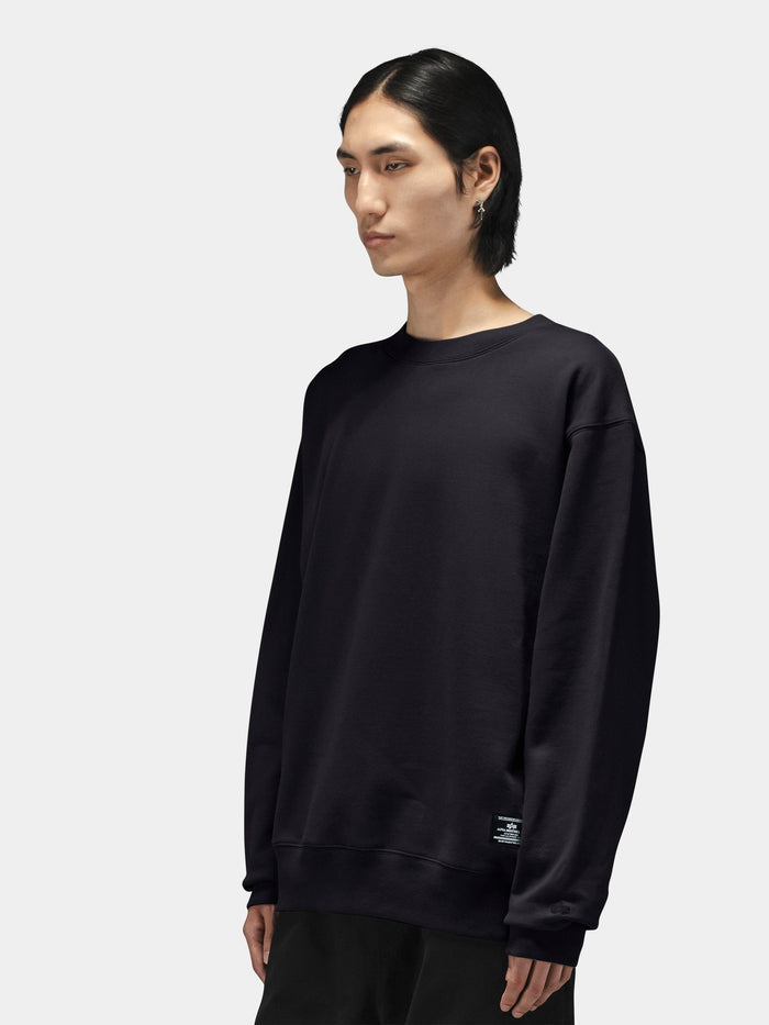 Alpha Industries Patched Crewneck, black, paired with black pants.