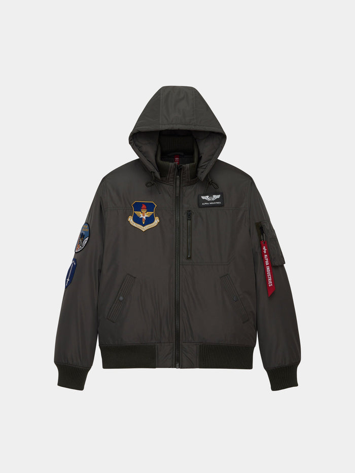 Alpha Industries Patched Hooded Rib Flight Jacket in Replica Grey with chest and sleeve patches, front pockets, utility pocket.