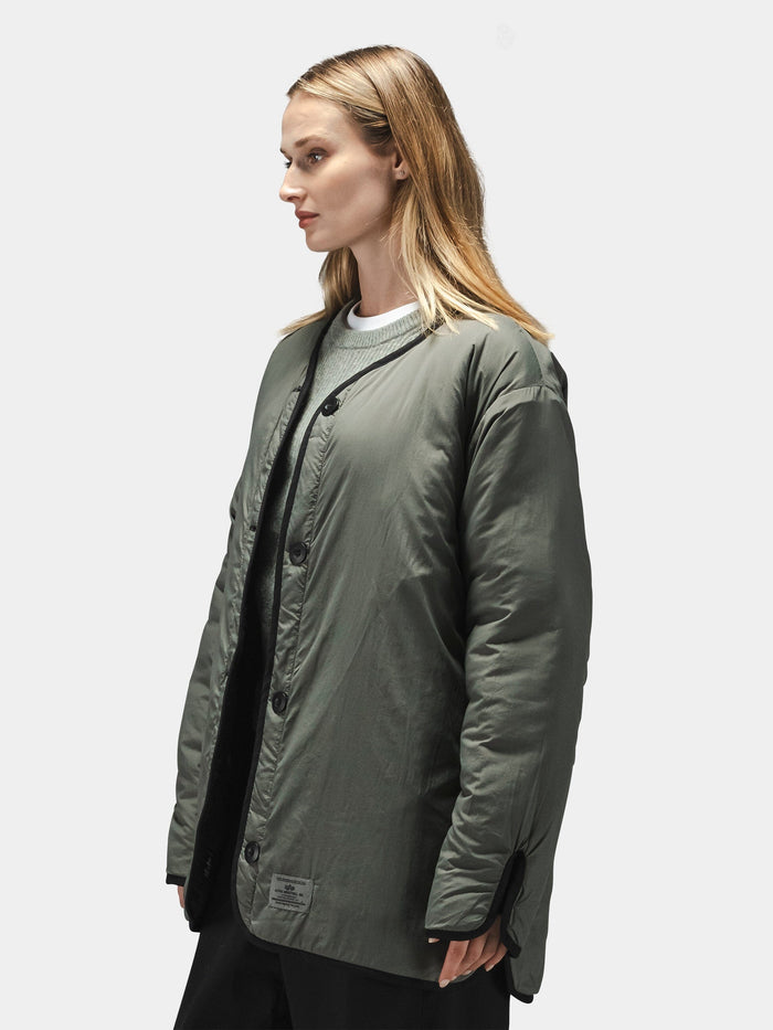 Alpha Industries Reversible Als/92 Mod Liner Womens, olive-green nylon ripstop quilted jacket over gray top.