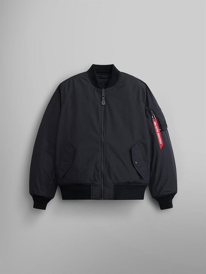 A black Reversible Onion Quilted MA-1 Bomber Jacket by Alpha Industries, featuring a front zipper, ribbed cuffs and hem, and a red tag on the pocket of the left sleeve.