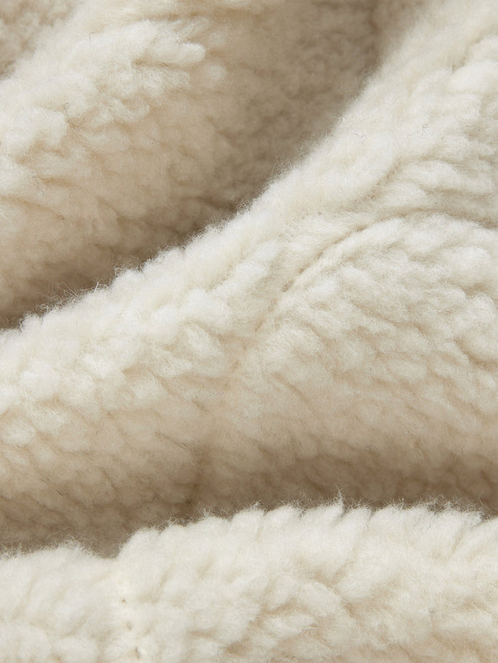 Sherpa Onion Quilting Vest by Alpha Industries featuring cream fleece fabric with textured surface and subtle folds.