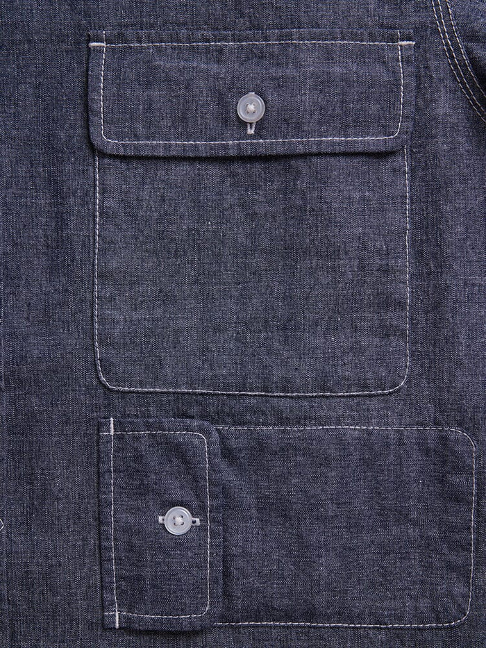 Alpha Industries Short Sleeve Multi Pocket Shirt, dark blue denim, two rectangular flap pockets with button closures, white stitching.