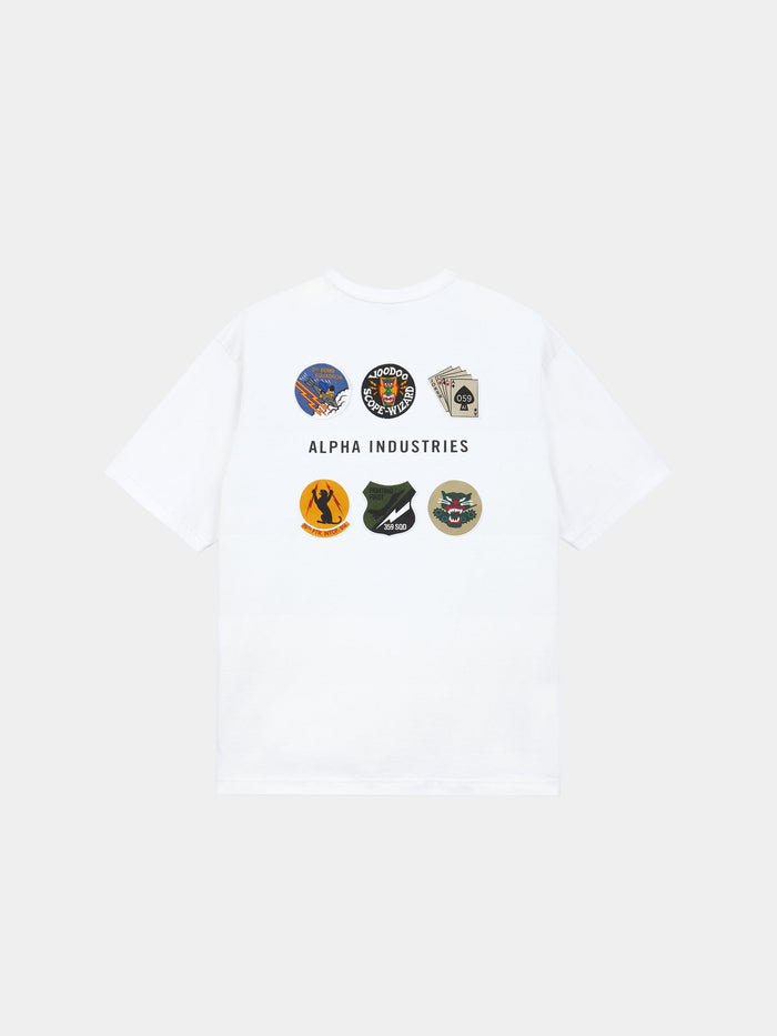 The Alpha Industries Short Sleeve Patched Tee in white with eight military-inspired patches and Alpha Industries text on back.