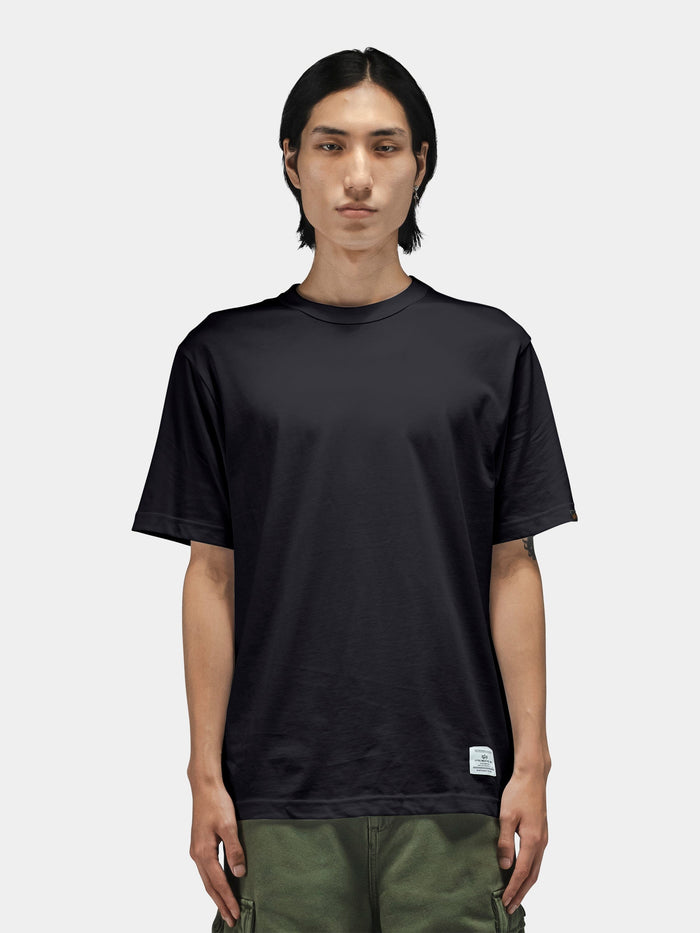 Alpha Industries Short Sleeve Regular Tee in black, paired with green pants.
