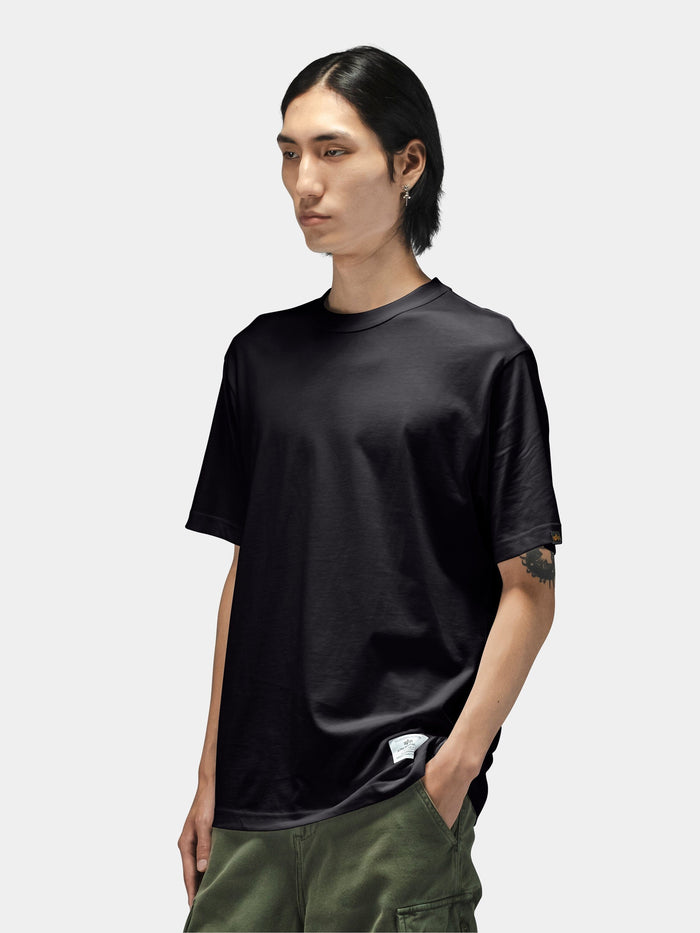Alpha Industries Short Sleeve Regular Tee in dark color, paired with green pants.