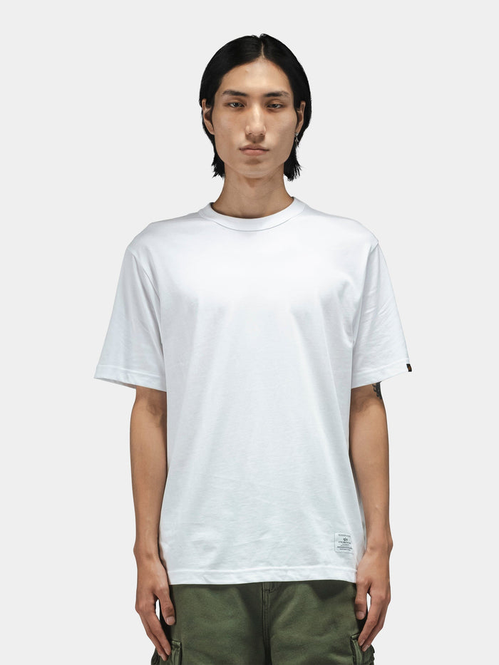 Alpha Industries Short Sleeve Regular Tee in white, paired with olive green pants.