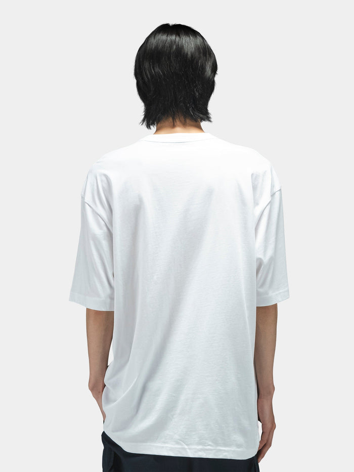 Alpha Industries Short Sleeve Relaxed Tee, dark color, paired with dark pants. Simple tee design.
