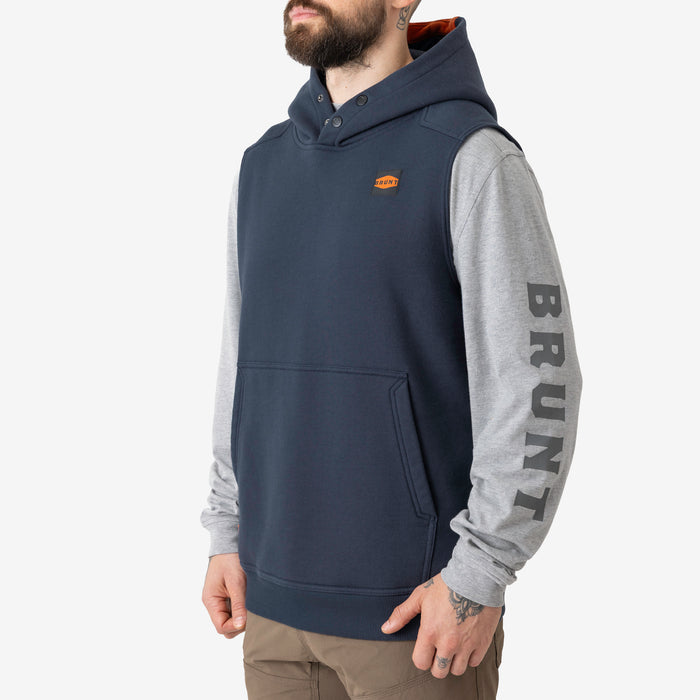 45 degree angle of the left side of the BRUNT sleeveless water resistant workwear hoodie in navy blue with BRUNT high quality long sleeve pocket tee in light grey underneath